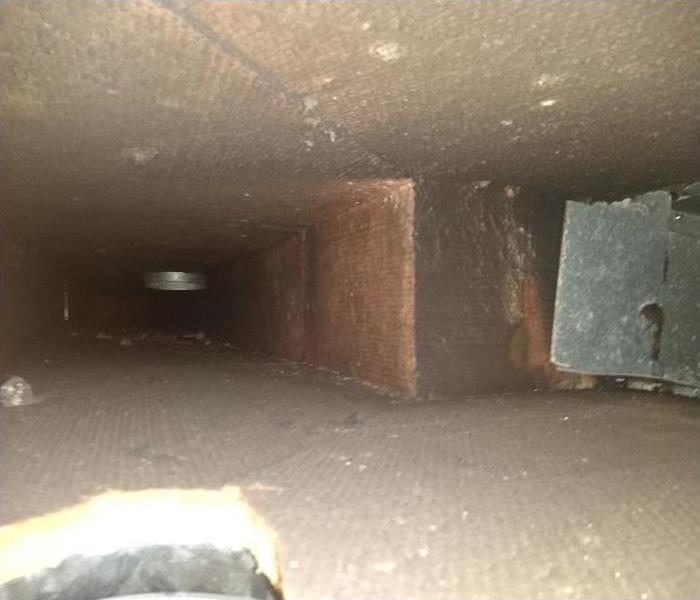 Interior of HVAC ductwork that has been affected by soot